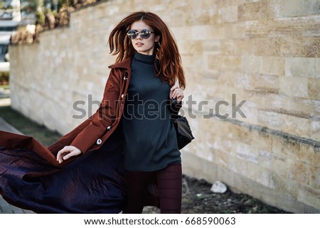Young beautiful woman in sunglasses outdoors in the city.
