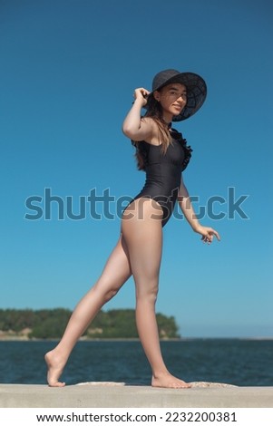 young beautiful woman in swimsuit on the beach