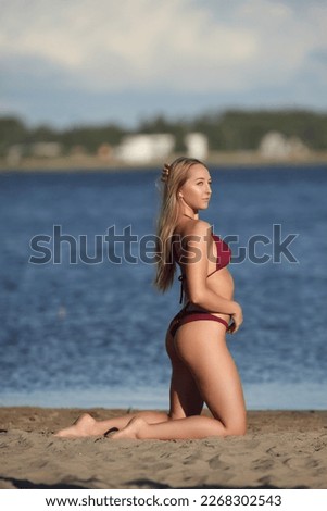 young beautiful woman in swimsuit on the beach