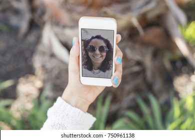 Young Beautiful Woman Taking A Selfie On Her Mobile Phone. View On The Screen, Hand Holding Mobile Phone