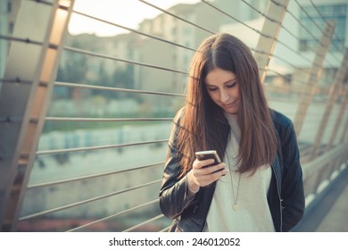 Young Beautiful Woman In Town Using Smartphone