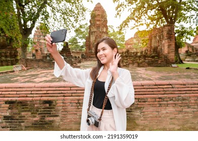 Young Beautiful Woman Traveling And Taking Photo At Thai Historical Park, Holidays And Cultural Tourism Concept.