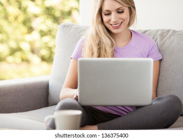 Young Beautiful Woman Using A Laptop Computer At Home