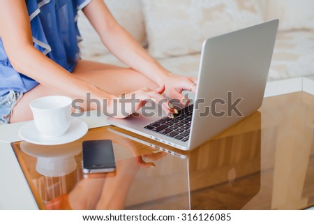 young beautiful woman using a laptop computer at home. Young adult using laptop outdoors.Portrait of student girl working on laptop.Sensual woman working at hote and drinking hot coffee,working hard