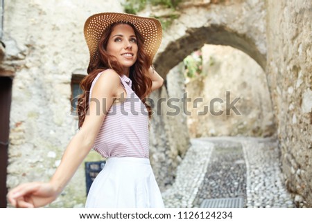 Young beautiful woman walking the streets of an Italian town