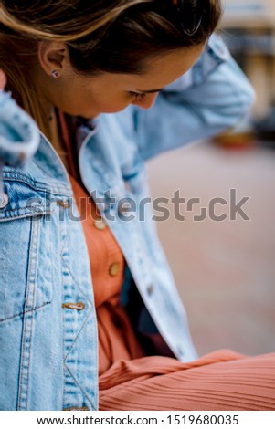 Similar – Frau mit Jeansjacke, blauer Bluse und silberner Armbanduhr.