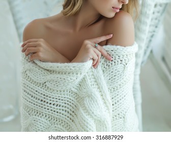 Young Beautiful Woman In Warm Knitted Handmade Clothes At Home. Model Fashion Shooting. Autumn, Winter Season. 