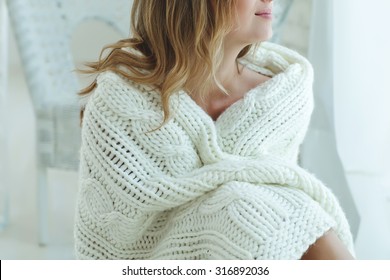 Young Beautiful Woman In Warm Knitted Handmade Clothes At Home. Model Fashion Shooting. Autumn, Winter Season. 