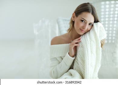 Young Beautiful Woman In Warm Knitted Handmade Clothes At Home. Model Fashion Shooting. Autumn, Winter Season. 