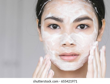 Young Beautiful Woman Washing Her Face With Soap. Studio Shot.