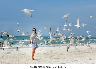 Young Beautiful Woman Watching The Seagulls Flying - Flock Of Birds, Siesta Key Beach, Florida 