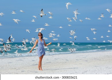 Young Beautiful Woman Watching The Seagulls Flying - Flock Of Birds, Siesta Key Beach, Florida