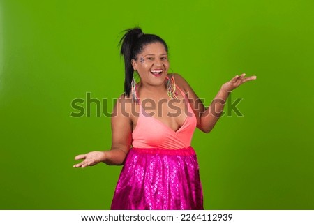 Young beautiful woman wearing carnival costume over isolated green background surprised and pointing to the side