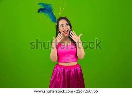 Young beautiful woman wearing carnival costume over isolated green background shouting and screaming loud to side with hand on mouth