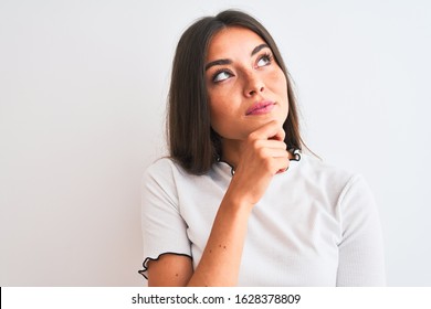 Young Beautiful Woman Wearing Casual T-shirt Standing Over Isolated White Background Serious Face Thinking About Question, Very Confused Idea