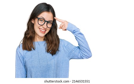 Young Beautiful Woman Wearing Casual Clothes And Glasses Smiling Pointing To Head With One Finger, Great Idea Or Thought, Good Memory 