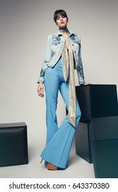 Young Beautiful Woman Wearing Flared Trousers And Cardigan