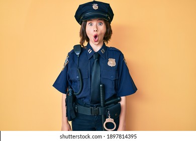 Young Beautiful Woman Wearing Police Uniform Afraid And Shocked With Surprise Expression, Fear And Excited Face. 