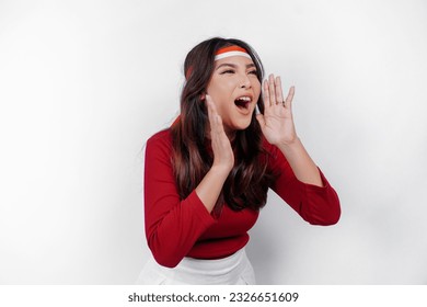 Young beautiful woman wearing a red top shouting and screaming loud with a hand on her mouth. Indonesia's independence day concept. - Powered by Shutterstock