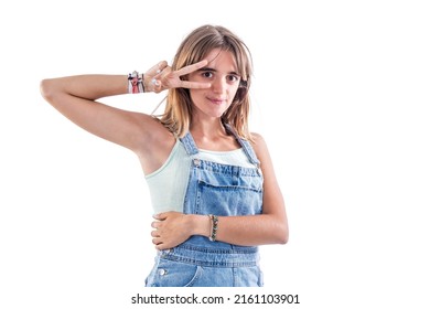 Young Beautiful Woman Wearing Texan Jumpsuit Against White Wall Doing Peace Symbol With Fingers Over Face, Smiling Cheerful Showing Victory