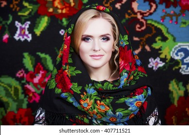Young beautiful woman wearing a traditional headscarf. Professional Make up. Beautiful Fashion Model Girl. Creative Hairstyle, Makeup and Nail Polish