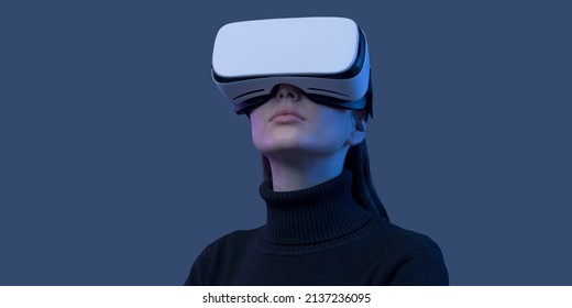 Young beautiful woman wearing a VR headset and experiencing virtual reality, futuristic technology concept - Powered by Shutterstock