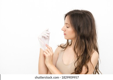 A Young Beautiful Woman Wearing A White Cotton Glove For Skin Care