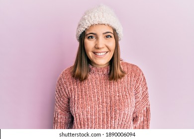 Young Beautiful Woman Wearing Wool Sweater And Winter Hat With A Happy And Cool Smile On Face. Lucky Person. 