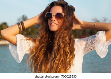 Young Beautiful Woman In White Dress With Natural Long Hair On Summer Vacation, Bohemian Style, Sunglasses, Sunny, Tropical Beach, Romantic Mood, Smiling, Happy