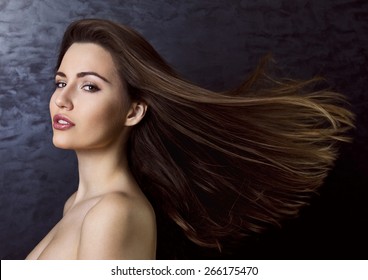 Young Beautiful Woman With Wind In Her Brown Long Hair. 