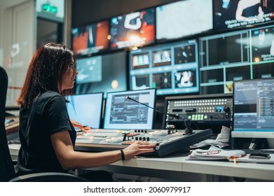 Young beautiful woman working in a broadcast control room on a tv station - Shutterstock ID 2060979917