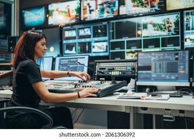 Young beautiful woman working in a broadcast control room on a tv station - Shutterstock ID 2061306392