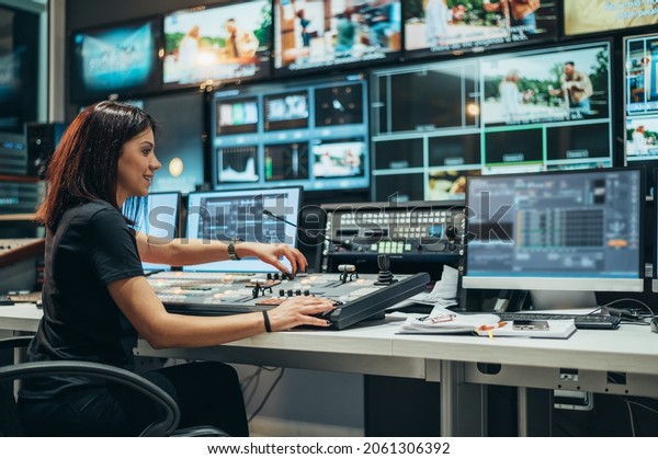 Young beautiful woman working in a broadcast\
control room on a tv\
station