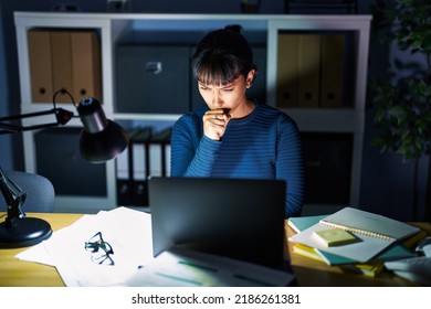 Young Beautiful Woman Working At The Office At Night Feeling Unwell And Coughing As Symptom For Cold Or Bronchitis. Health Care Concept. 