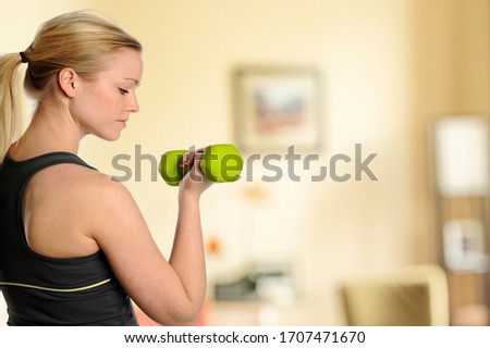 Young beautiful woman workingout inside her livingroom at home