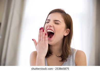 Young Beautiful Woman Yawning At Home