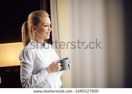 Young beautiful women enjoying in coffee.Businesswoman working from a hotel room.