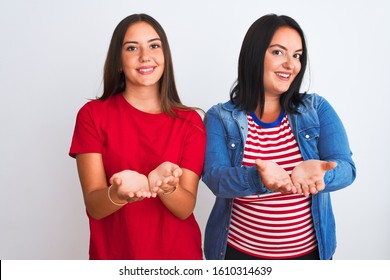 Young beautiful women wearing casual clothes standing over isolated white background Smiling with hands palms together receiving or giving gesture. Hold and protection