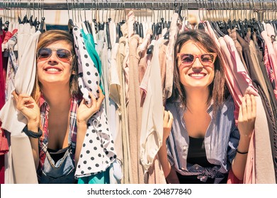 Young beautiful women at weekly cloth market - Best friends sharing free time having fun and shopping in old town on sunny day - Girlfriends enjoying everyday life moments - Looking at camera view - Shutterstock ID 204877840