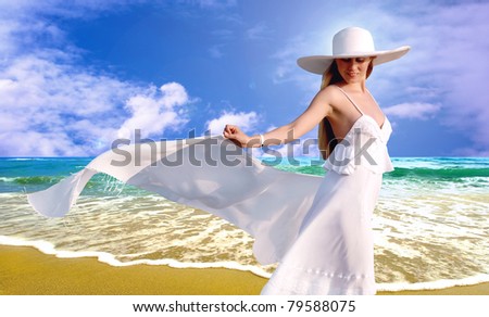 Young beautiful women in the white with pareo on the sunny tropical beach