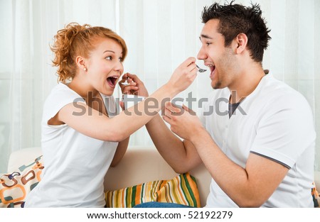 Young Beauty Girl And A Handsome Boy Eating Yoghurt Young Beauty Girl And A Handsome Boy Eating Yoghurt