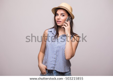 Young beauty girl in hut speak on phone on grey background