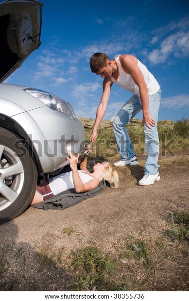 young beauty girl try\
to repair big car