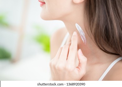 Young Beauty Woman Applying Cream Or Sunscreen On Her Neck