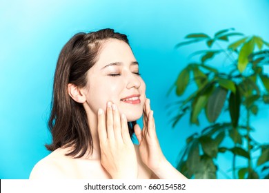 Young Beauty Woman Massaging Her Face. Facial Massage Concept.