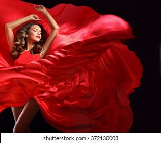 Young beauty woman in red waving flying  dress. Dancer in silk dress. - Shutterstock ID 372130003
