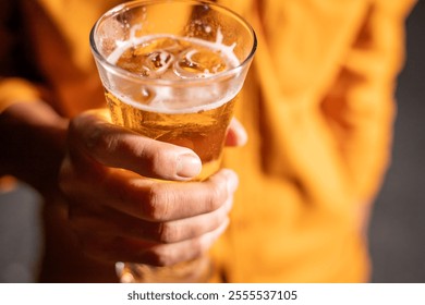 Young beer man holding a glass of beer in his hand, drinking craft beer to test the taste and color of beer in a craft brewery. - Powered by Shutterstock