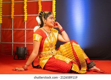 Young Bharatnatyam Dancer Sitting On Stage By Laughing After Dancing - Concept Of Taking Break, Relaxtion And Professional Dancer.