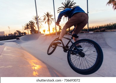 A Young Bike Rider Doing A Trick In A Bowl.