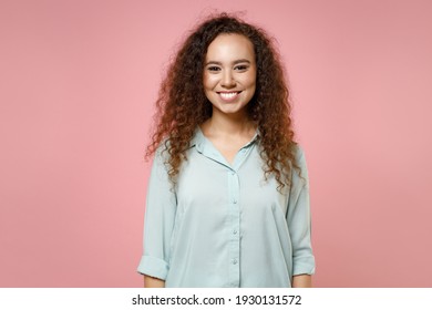 Young Black African American Happy Smiling Positive Friendly Curly Woman 20s Wearing Blue Casual Shirt Looking Camera Isolated On Pastel Pink Color Background Studio Portrait. People Lifestyle Concept